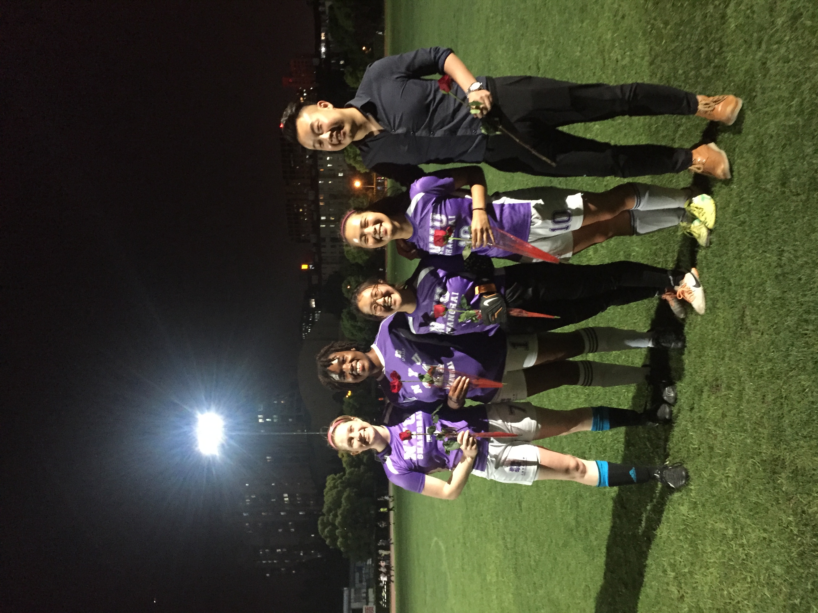 Four NYU Shanghai students pose for a picture with their soccer coach