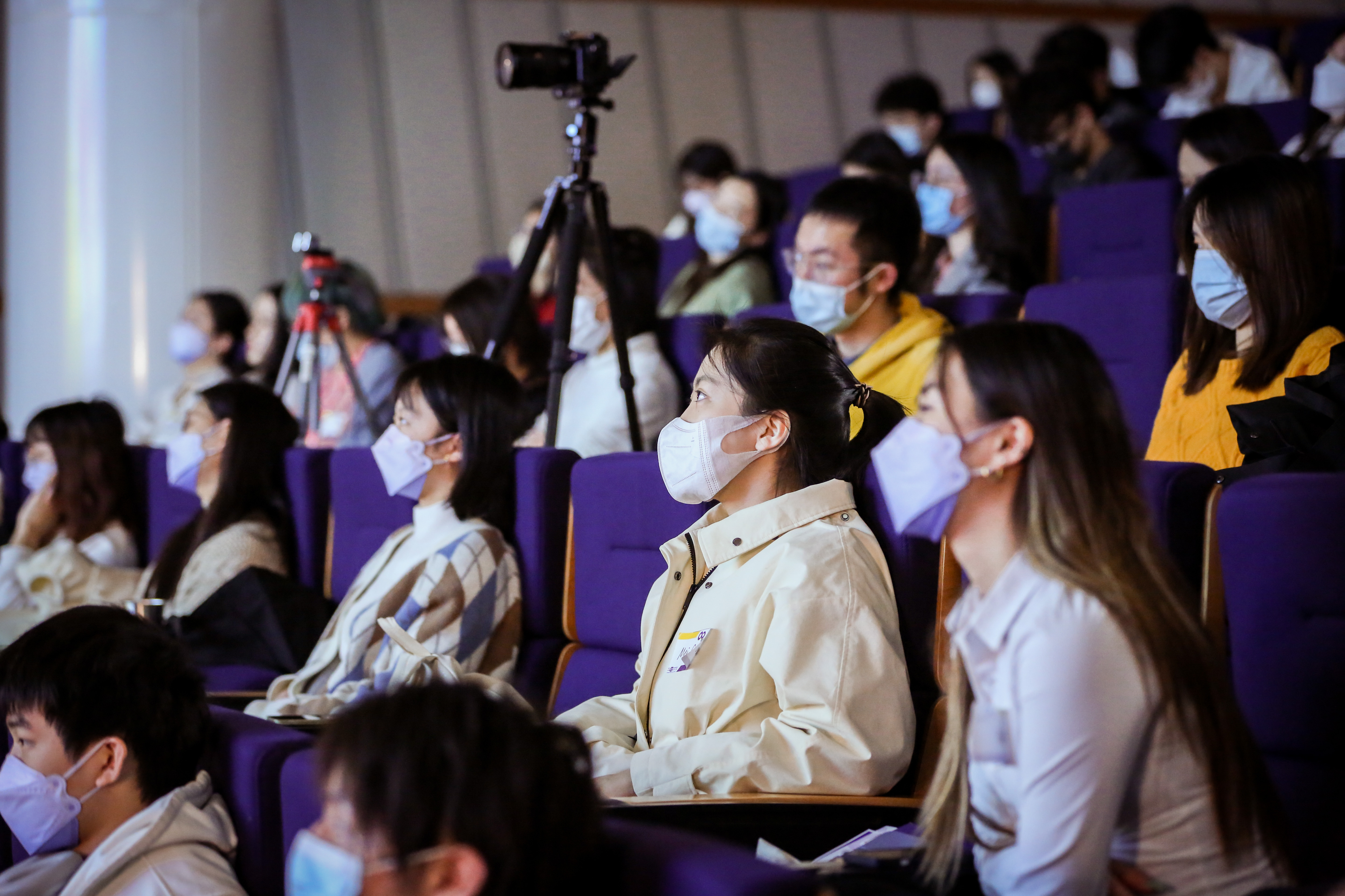 students sit in the audience and watch the keynote address