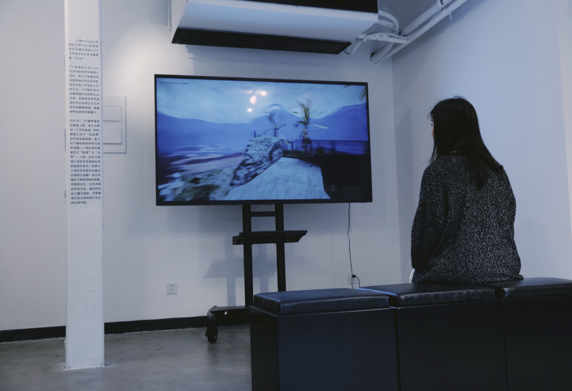 A student sits and watches a project on the TV 