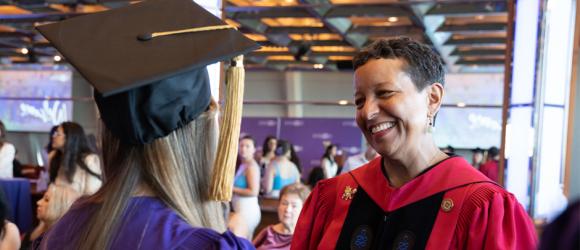 Professor Almaz Zelleke greets a graduate. 