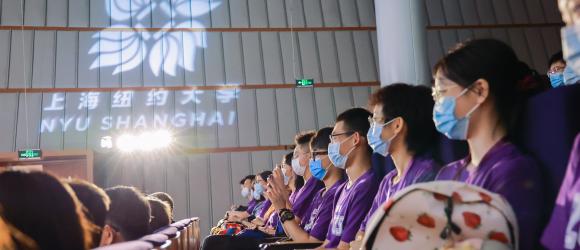 NYU Shanghai spotlight illuminates room filled with students