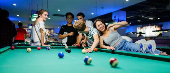 Class of 2022 students playing pool