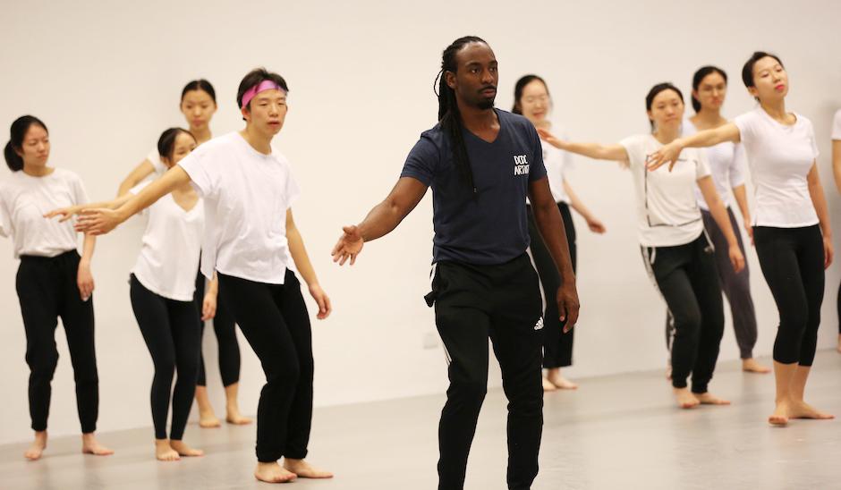 DCDC was founded 50 years ago in Dayton, Ohio, to create performance opportunities for dancers of color and remains rooted in the African American experience. At NYU Shanghai, dancers introduced students to Nigerian dance steps and music. DCDC’s Devin Baker (center), shows students how to convey emotion through arm movements.