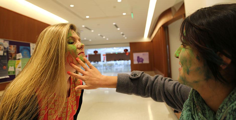 To celebrate Holi Festival, a Hindu festival with colored powder and water fights, the Food and Festivals Club dusts students' faces with colored chalk. March 6, 2015. (Photo by Annie Seaman)