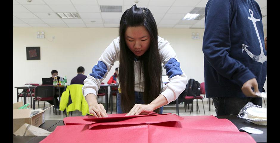 Students prepare for the upcoming Spring Festival holiday by creating traditional Chinese paper cuttings. February 1, 2015. (Photo by Annie Seaman)