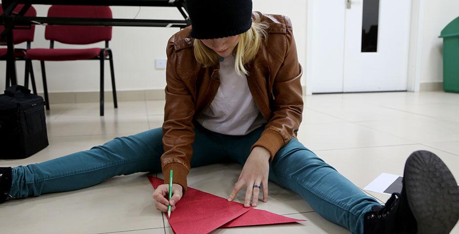 Students prepare for the upcoming Spring Festival holiday by creating traditional Chinese paper cuttings. February 1, 2015. (Photo by Annie Seaman)