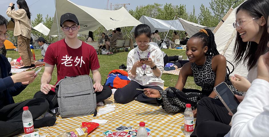 [Beyond the Magnolia House] April 15 2023, a beautiful sunny spring day, a group of 10 first-year students joined the Biking & Picnic event. The biking group biked through World Expo Park along the Huangpu River and met up with the picnic group at Qiantan Leisure Park Camping Zone (near Youcheng Park Gate 6). Students then enjoyed snacks, beverages, and McDonald’s as well as playing fun board games and frisbees on the grass.