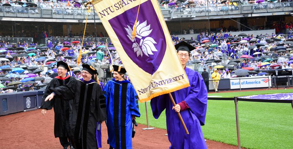 NYU Shanghai graduate Su Han'18 carried the banner for the university, alongside representatives from all of NYU's schools and campuses ( Photo by: Leo Sorel )