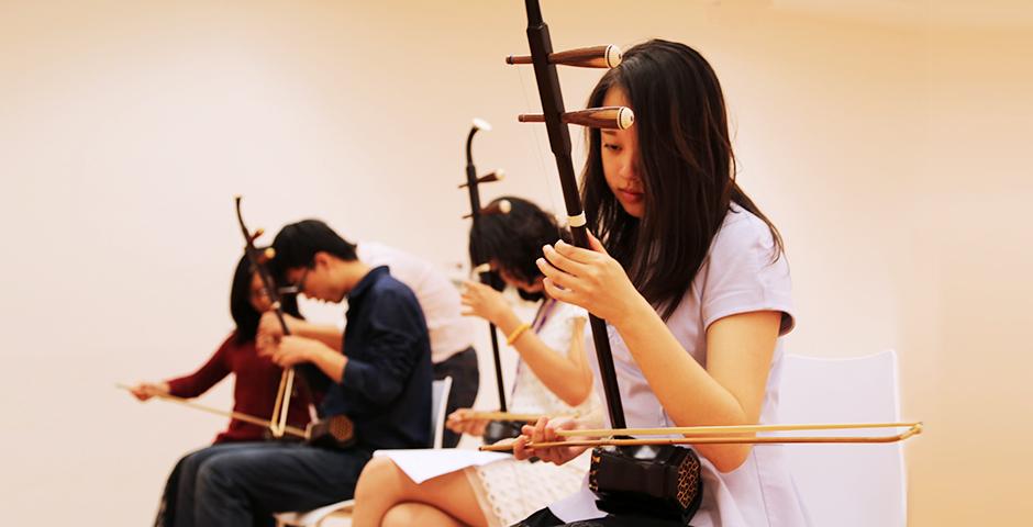 Students practice playing the traditional Chinese instrument, the Er Hu, October 20, 2014. (Photo by Annie Seaman)