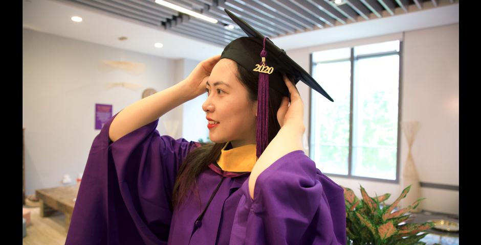 Data Analytics & Business Computing graduate, Xinye Gong, MS ’20, adjusts her cap.